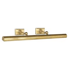 two brass handles on a white wall