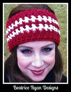 a woman wearing a red and white crocheted headband