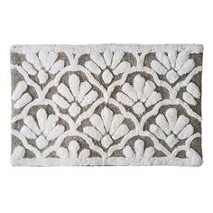 a bath mat with an intricate design on the front and back side, in grey and white