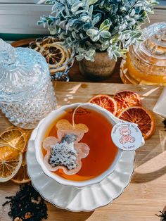 a bowl of soup with orange slices and tea on the side, next to an assortment of dried fruit