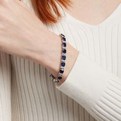 Set a sophisticated tone when you wear this cushion-cut blue and white lab-created sapphire alternating link bracelet in silver. Crafted in sterling silver This design showcases 6.0mm cushion-cut bright blue lab-created sapphires. Pairs of dainty white lab-created sapphires complete the alternating pattern while adding shimmer to the look. This 7.25-inch bracelet secures with a tongue and groove clasp. Sapphire Tennis Bracelet For Formal Occasions, Formal Sapphire Tennis Bracelet In Fine Jewelry Style, Elegant Sapphire Tennis Bracelet With Jubilee Band, Elegant Blue Tennis Bracelet For Formal Occasions, Formal Sapphire Tennis Bracelet Fine Jewelry, Elegant Sapphire Tennis Bracelet For Anniversary, Formal Blue Tennis Bracelet With Diamond Accents, Classic Sapphire Sterling Silver Bracelets, Elegant Blue Tennis Bracelet With Diamond Accents