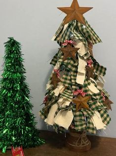 a christmas tree made out of strips of paper and ribbon with a star on top