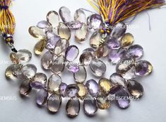 the beads are purple and have tassels attached to each bead, along with an orange tassel