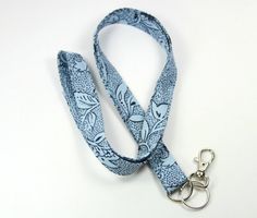 This cute lanyard has beautiful blue and black design. It is perfect for any occasion.You can leave me a convoy if you need a different size.You can have a wardrobe of lanyard to match your outfit. This lanyard is made of soft 100% cotton fabric to give a comfortable feel around your neck. This lanyard is easy to take care. You can spot clean and throw in a washer and hang dry. If you want you can iron and it is ready to use. These lanyards are perfect if you have metal allergy. Each of these la Handmade Blue Lanyards As Gifts, Handmade Blue Lanyard As Gift, Handmade Blue Lanyards For Gifts, Blue Lanyards With Key Leash As Gift, Blue Lanyard With Key Leash As Gift, Yoobi Lanyard, Blue Lanyard With Key Leash For Gift, Blue Lanyard With Key Leash For Personal Use, Lanyard Blue