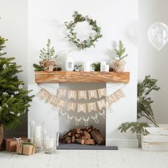 a christmas mantle decorated with garland and decorations