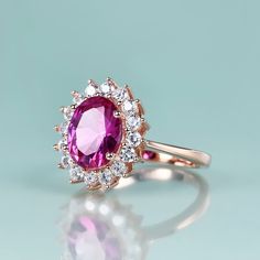 Inspired by Princess Diana’s Engagement Ring and Kate Middleton’s Engagement Ring This beautiful Princess Diana engagement ring with pink sapphire is inspired by Princess Diana's engagement ring, which is a 12-carat oval sapphire surrounded by 14 round diamonds set in 18-karat white gold. It is also Kate Middleton's engagement ring. It Features a Pink Sapphire Stone With Vivid Colors This pink sapphire ring features one lab-created pink sapphire stone and 16 clear cubic zirconia stones. Sapphire Princess Diana Engagement, Kate Middleton Engagement Ring, Princess Diana Engagement Ring, Diana Engagement Ring, Sapphire Birthstone Ring, Princess Diana Ring, Engagement Ring Pink, Sterling Silver Birthstone Ring, Diana Ring