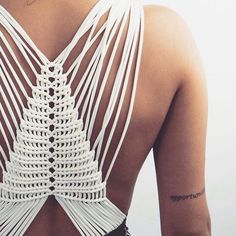 the back of a woman's bra with crochet details on her chest