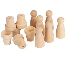 wooden pegs and cups are arranged on a white surface, including one for each child's head