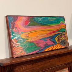 a painting is sitting on top of a mantle