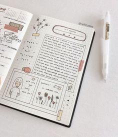 an open notebook with drawings on it and a pen next to it in front of the page