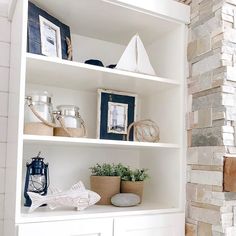 a white book shelf filled with books and other items