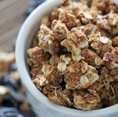 a bowl filled with granola sitting on top of a table