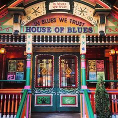 the front entrance to an old fashioned building with colorful decorations on it's sides