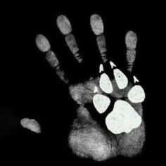 a black and white photo of a person's hand with an animal print on it