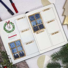 an open planner book with christmas decorations around it