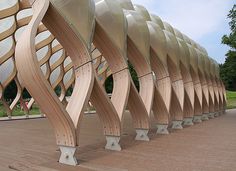 the curved wooden structure is on display outside