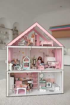 a doll house with furniture and accessories inside