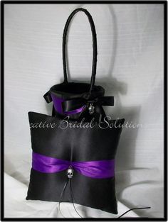 a black and purple bag with a bow on it