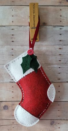 a felt christmas stocking hanging on a wooden wall