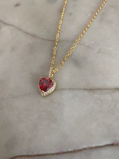 Ruby red heart jewel pendant with a crystal paved bail measuring 1.8 cm x 1 cm. Hung on a gold-plated chain which measures 45.7 cm (18 inches). Comes in a black velvet cushioned box. As seen in last photo. Free of charge. INTERNATIONAL BUYERS please choose the tracking option if you would like your order to be tracked. FREE tracking upgrade with 3 items or more purchased. JEWELLERY CARE please don't wear plated jewellery in the shower, bath or swimming for the plating to last longer. Red Heart Cut Necklace For Formal Occasions, Gold Plated Heart Necklace For Party, Red Gemstone Heart Cut Necklace, Elegant Red Gemstone Heart Necklace, Red Gold Plated Necklace For Anniversary, Red Heart Pendant For Formal Occasion, Red Heart Jewelry For Formal Occasions, Red Heart Cut Necklace For Party, Formal Valentine's Day Gold Plated Heart Necklace