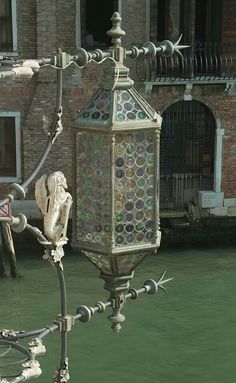 an ornate street light in front of a building