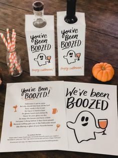 two halloween booze bags and some candy sticks on a table with paper tags that say, you've been boozed