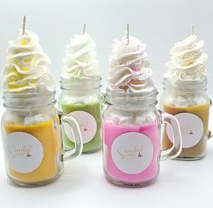 four jars filled with cupcakes and marshmallows on top of each other