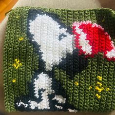 a crocheted square with a cat in the hat on it's side