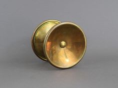 an antique brass door knob on a gray background