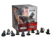 godzilla figurines are displayed in front of a box with the figures on it