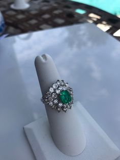 Stunningly gorgeous, Emerald & Diamond Ring set in Platinum. Handmade. Beautiful quality piece of jewelry. Approximately 2.20 ct. in Diamonds, Emerald is nice color & measures 1.15 ct. Diameter of ring is 19mm, size 6 but can be sized. Circa 1950's Elegant Green Diamond Gemstones, Luxury Gia Certified Emerald Gemstones, Green Platinum Gemstones Fine Jewelry, Fine Green Platinum Gemstones Jewelry, Luxury Emerald Gemstones With Prong Setting, Oval Emerald Gemstones With Halo Setting, Luxury Emerald Ring With Diamond, Elegant Tsavorite Gemstones For Anniversary, Fine Jewelry Diamond Cluster Gemstones