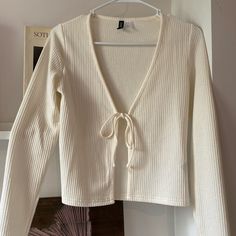 Fitted White Ribbed Cardigan With Tie Front Detail. Hits Above Waist, Never Worn, In Excellent Condition. White Ribbed Cardigan For Spring, H&m Cream Long Sleeve Top, H&m V-neck Sweater For Spring, H&m Long Sleeve Cream Top, Casual H&m V-neck Cardigan, H&m White Spring Sweater, H&m White Sweater For Spring, Fitted Long Sleeve H&m Cardigan, H&m Fitted Long Sleeve Cardigan