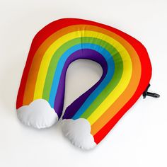 a rainbow shaped pillow on top of a white table