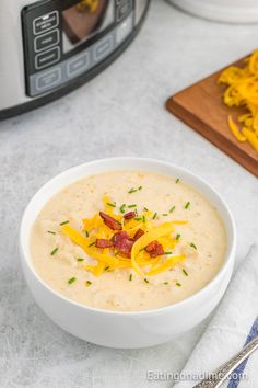 a bowl of soup with cheese and bacon in it next to an instant pressure cooker