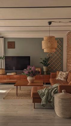 a living room filled with furniture and a flat screen tv on top of a wooden table