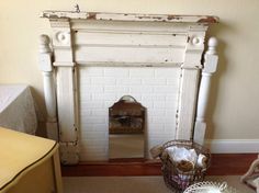 an old fireplace in the corner of a room with a basket on the floor next to it