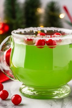 a green cup filled with liquid and topped with cherries