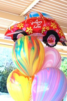 some balloons are stacked on top of each other in the shape of cars and flowers