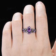 a woman's hand with a purple ring on it