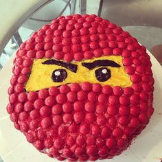 a cake with raspberries on it that looks like a man's face