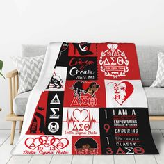 a red and black blanket on a couch with white walls in the background that says i am