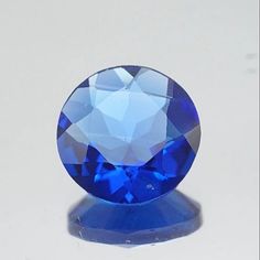 a blue diamond sitting on top of a white table