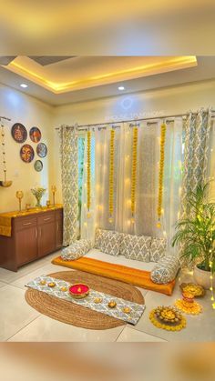 a living room filled with lots of furniture next to a window covered in yellow curtains