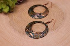 Item Overview *Handmade item *Raw Copper Patina *Ships anywhere in the US from Bellingham, Washington Item Details Unique Copper patina hoop earrings. Made of raw copper that has hand hammered, domed and Patinated by me Patina is a passion of mine because we love the results.  This process of this coloring of patina takes five days.   This pair is a beautiful copper earrings is accented with black, blues, greens, burnt orange and bronze hues.   This coloring is different every time and it's own unique piece Patina is a unique finish and no two pair will be exactly alike but will strongly resemble the picture. Product Overview - Hand hammered, dome shaped and patina - Very light weight and versatile -The copper patina pieces are covered by a thin layer of lacquer in order to save natural co Artisan Small Hoop Copper Jewelry, Handmade Copper Round Hoop Earrings, Handmade Copper Hoop Earrings, Handmade Small Hoop Copper Earrings, Handmade Small Copper Hoop Earrings, Copper Dangle Hoop Earrings Gift, Unique Small Hoop Copper Earrings, Handmade Copper Circle Jewelry, Handmade Small Hoop Metal Earrings