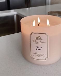 a pink candle sitting on top of a counter