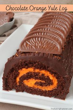 chocolate orange yule log on a white plate with an orange swirl in the center