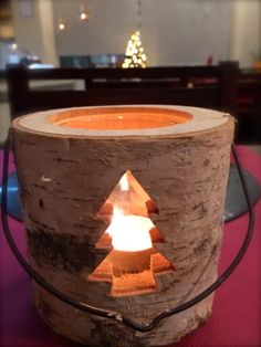 a candle that is sitting inside of a wooden container