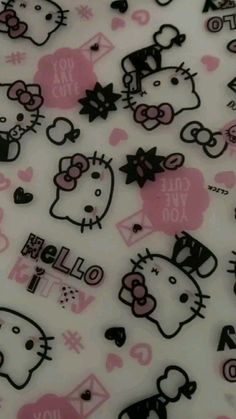 hello kitty stickers on a white surface with pink hearts and black cats in the background