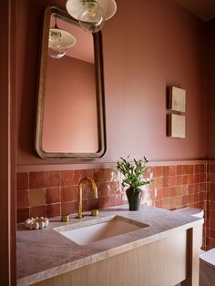 a bathroom with a sink and mirror in it