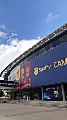 the outside of a stadium with people walking around